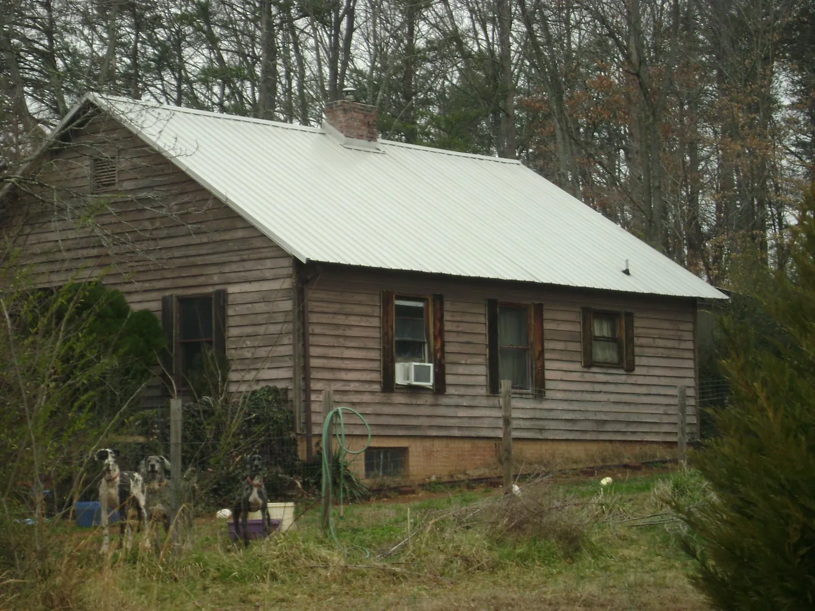 White metal roof on an old wood sided farmhouse, from a Metal Roof Installation job in Talmage